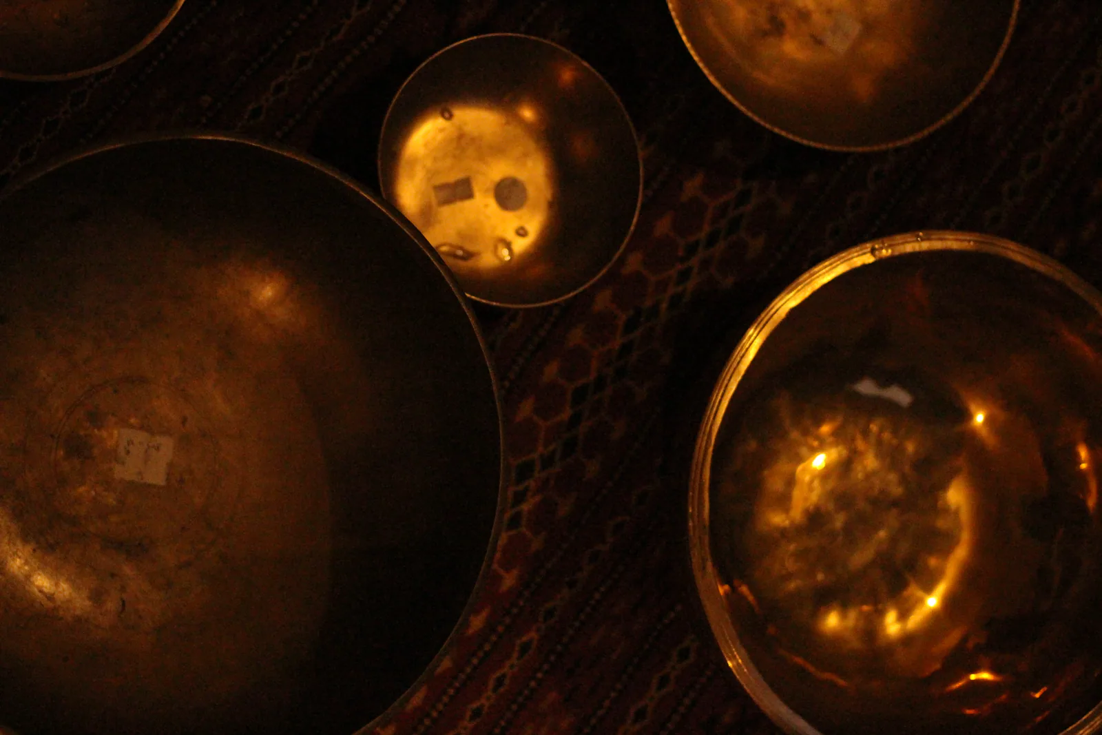 Reflejos dorados en el interior de varios cuencos del Himalaya